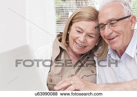 Stock Photo - Senior couple using laptop. Fotosearch