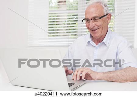 Senior man using laptop View Large Photo Image Stock Image - Senior man using laptop. Fotosearch