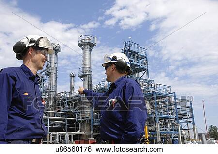 Two industrial workers on oil and gas refinery View Large Photo Image Stock Photograph - Two industrial workers on oil and gas refinery. Fotosearch