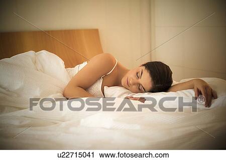 Stock Image - Woman asleep in bed. Fotosearch