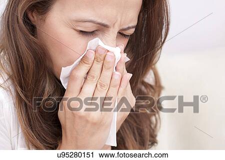 Woman blowing nose on tissue View Large Photo Image Stock Image - Woman blowing nose on tissue. Fotosearch