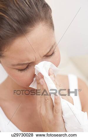 Woman blowing nose on tissue View Large Photo Image Stock Photo - Woman blowing nose on tissue. Fotosearch