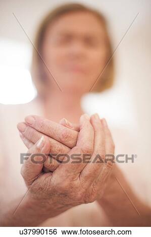 Stock Photograph - Woman holding hands, close up. Fotosearch