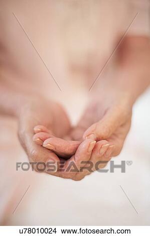 Picture - Woman holding hands. Fotosearch