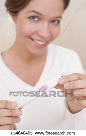 Woman holding positive pregnancy test View Large Photo Image Stock Photography - Woman holding positive pregnancy test. Fotosearch