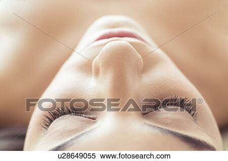 Woman lying on back with eyes closed View Large Photo Image Stock Photography - Woman lying on back with eyes closed. Fotosearch
