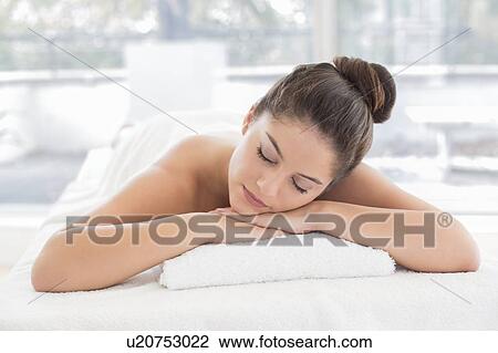 Woman lying on towel in spa View Large Photo Image Stock Image - Woman lying on towel in spa. Fotosearch