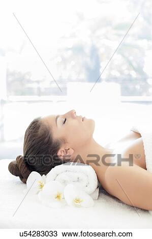 Woman lying on towel in spa View Large Photo Image Stock Image - Woman lying on towel in spa. Fotosearch