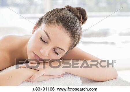 Woman lying on towel in spa View Large Photo Image Stock Photograph - Woman lying on towel in spa. Fotosearch