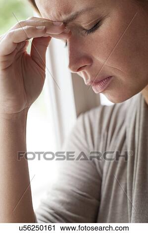 Stock Image - Woman rubbing eyes. Fotosearch