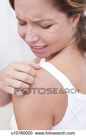Woman scratching shoulder View Large Photo Image Stock Image - Woman scratching shoulder. Fotosearch