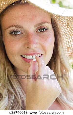 Stock Image - Woman taking tablet. Fotosearch