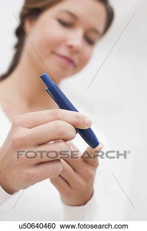 Woman testing glucose View Large Photo Image Stock Image - Woman testing glucose. Fotosearch