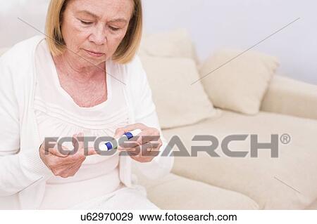 Woman testing glucose View Large Photo Image Stock Photo - Woman testing glucose. Fotosearch