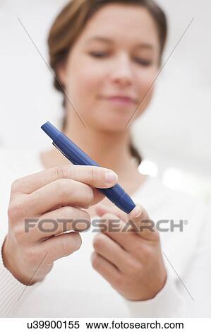 Woman testing glucose View Large Photo Image Stock Photography - Woman testing glucose. Fotosearch
