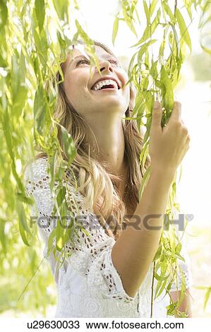 Woman touching green leaves View Large Photo Image Stock Image - Woman touching green leaves. Fotosearch