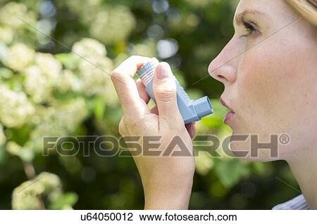 Woman using inhaler View Large Photo Image Stock Image - Woman using inhaler. Fotosearch