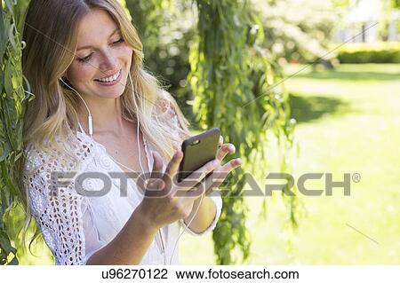 Stock Image - Woman using smartphone. Fotosearch