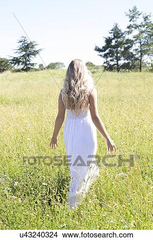 Woman walking in meadow View Large Photo Image Picture - Woman walking in meadow. Fotosearch