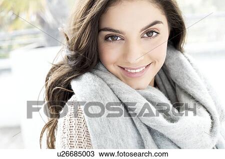 Stock Image - Woman wearing grey scarf. Fotosearch
