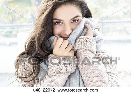 Woman wearing knitted sweater and scarf View Large Photo Image Stock Image - Woman wearing knitted sweater and scarf. Fotosearch