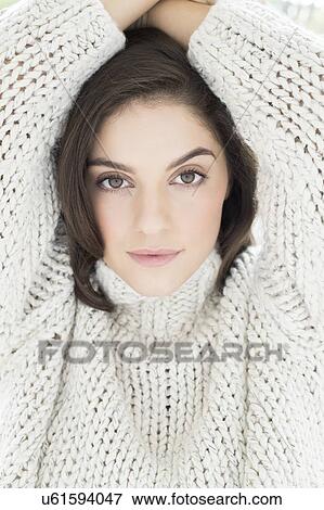 Woman wearing knitted sweater with arms up View Large Photo Image Stock Photo - Woman wearing knitted sweater with arms up. Fotosearch
