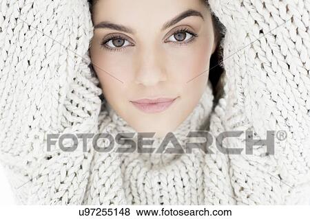 Stock Photo - Woman wearing knitted sweater with arms up. Fotosearch