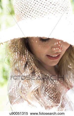 Stock Photography - Woman wearing sunhat. Fotosearch