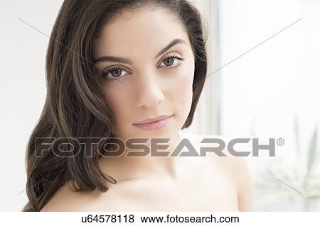 Stock Photo - Woman with brown hair looking at camera. Fotosearch