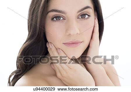 Stock Photo - Woman with brown hair with hands on face. Fotosearch