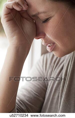 Picture - Woman with hand on forehead. Fotosearch