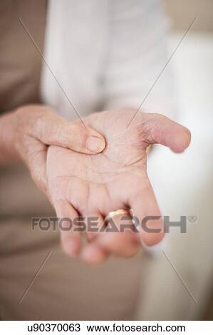 Stock Image - Woman with hand pain. Fotosearch