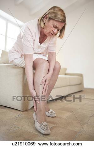 Stock Photo - Woman with leg pain. Fotosearch