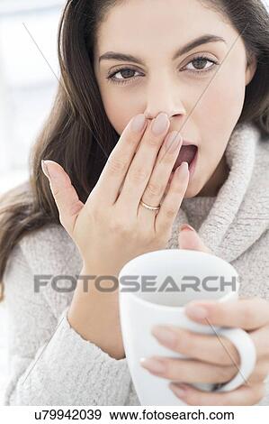 Woman with mug, yawning View Large Photo Image Stock Photo - Woman with mug, yawning. Fotosearch