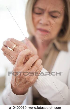 Stock Photo - Woman with wrist pain. Fotosearch