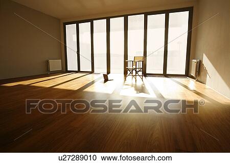 Chair and laptop in empty room View Large Photo Image Stock Image - Chair and laptop in empty room. Fotosearch