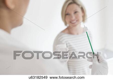 Stock Photo - Doctor holding cervical smear equipment. Fotosearch