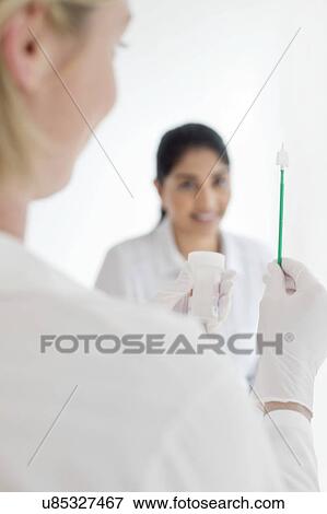 Stock Photo - Doctor holding cervical smear equipment. Fotosearch