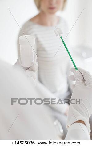 Stock Photograph - Doctor holding cervical smear equipment. Fotosearch