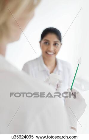 Stock Photography - Doctor holding cervical smear equipment. Fotosearch