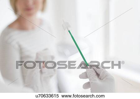 Stock Photography - Doctor holding cervical smear equipment. Fotosearch