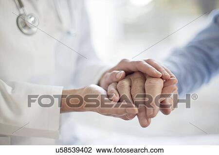 Female doctor holding patient's hand View Large Photo Image Stock Image - Female doctor holding patient's hand. Fotosearch