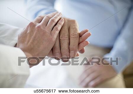 Female doctor holding patient's hand View Large Photo Image Stock Photo - Female doctor holding patient's hand. Fotosearch