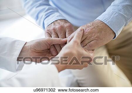 Female doctor holding patient's hands View Large Photo Image Stock Image - Female doctor holding patient's hands. Fotosearch