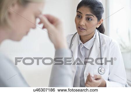 Stock Photograph - Female doctor talking to patient. Fotosearch