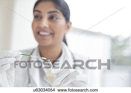 Female doctor testing urine View Large Photo Image Picture - Female doctor testing urine. Fotosearch