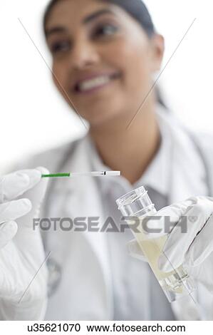Female doctor testing urine View Large Photo Image Stock Image - Female doctor testing urine. Fotosearch
