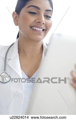 Picture - Female doctor using digital tablet. Fotosearch