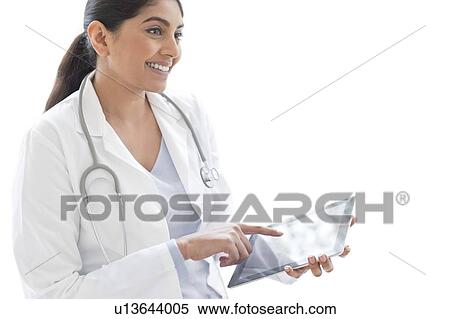 Stock Photography - Female doctor using digital tablet. Fotosearch