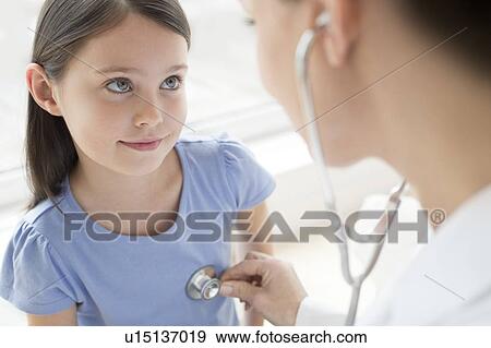 Female doctor using stethoscope View Large Photo Image Stock Photo - Female doctor using stethoscope. Fotosearch
